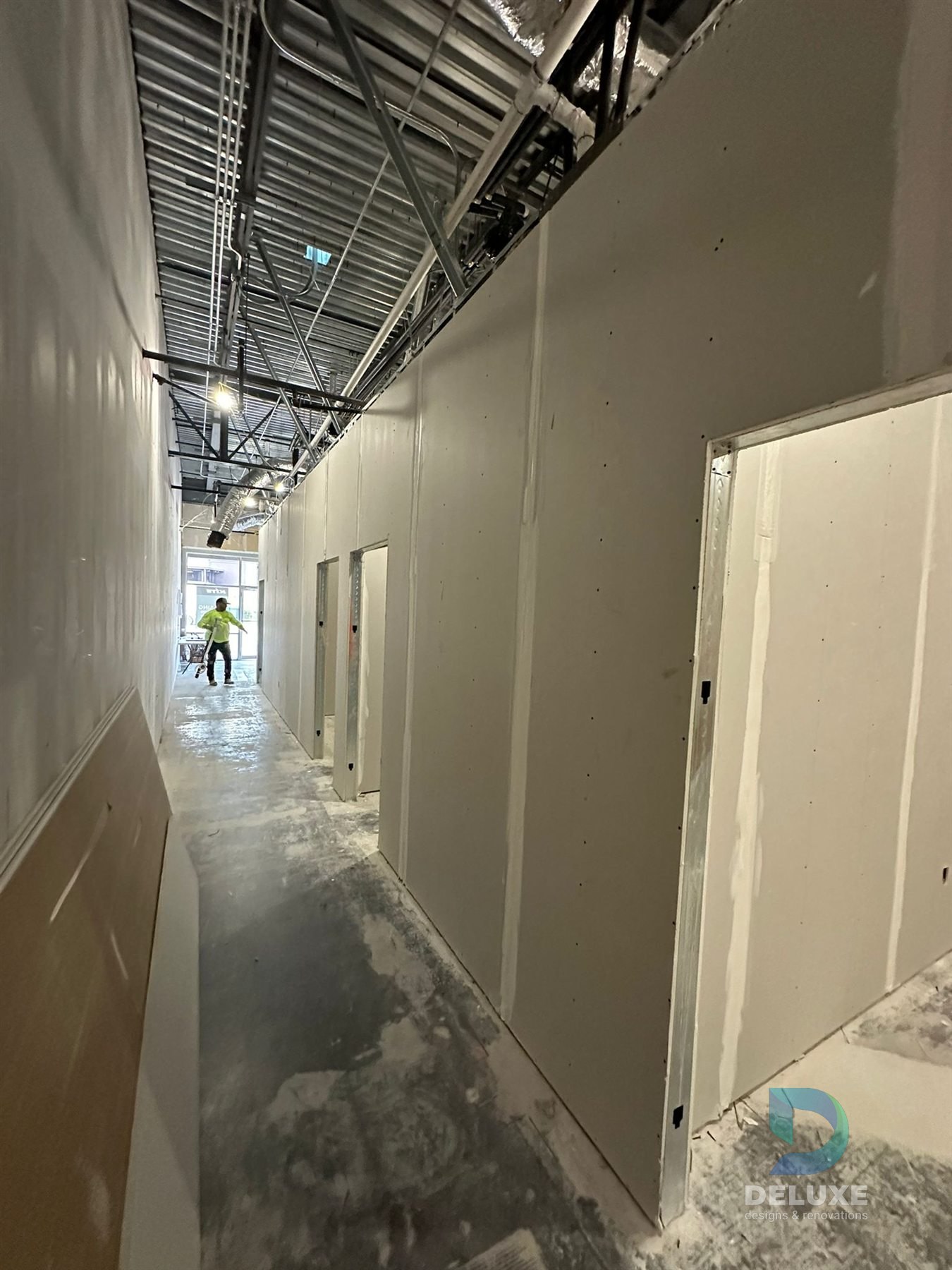 Milan Laser Valrico commercial buildout project with Deluxe Designs & Renovations watermark - Milan Laser Valrico Commercial Corridor Finish