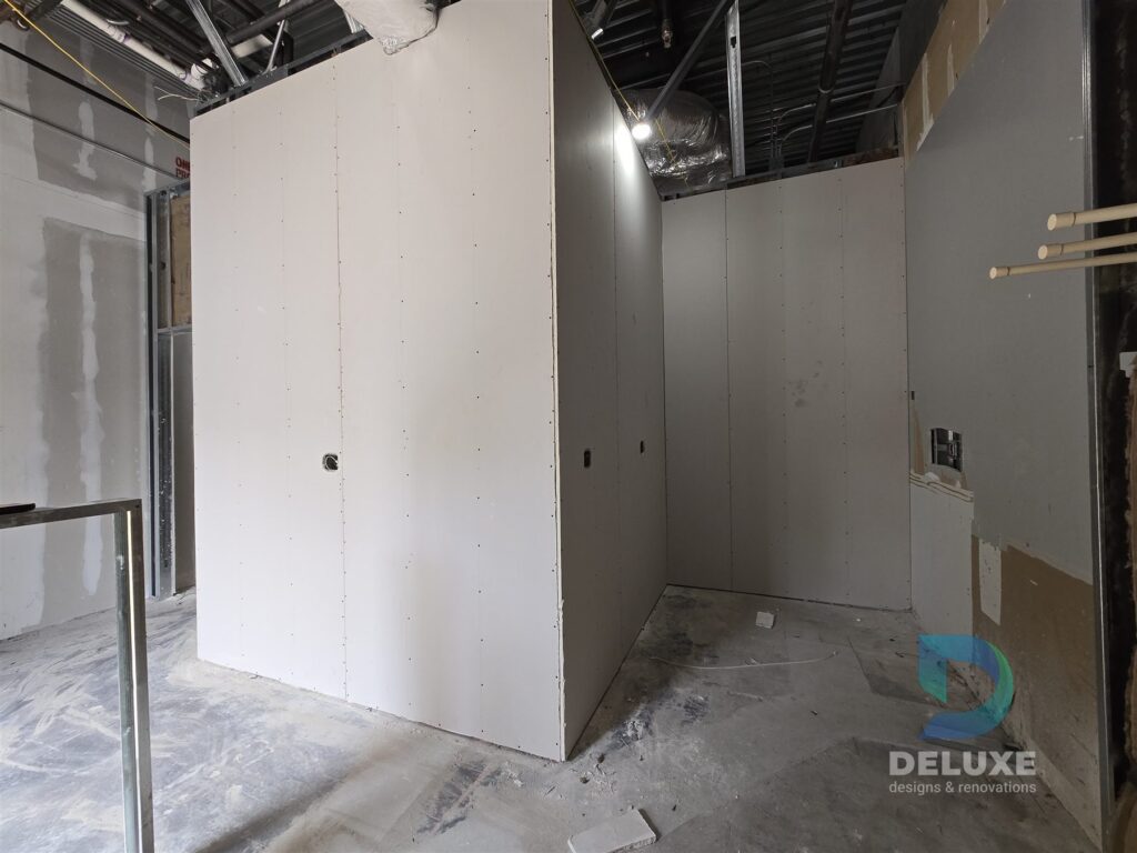 Milan Laser Valrico commercial buildout project with Deluxe Designs & Renovations watermark - Milan Laser Valrico Drywall Board Progress