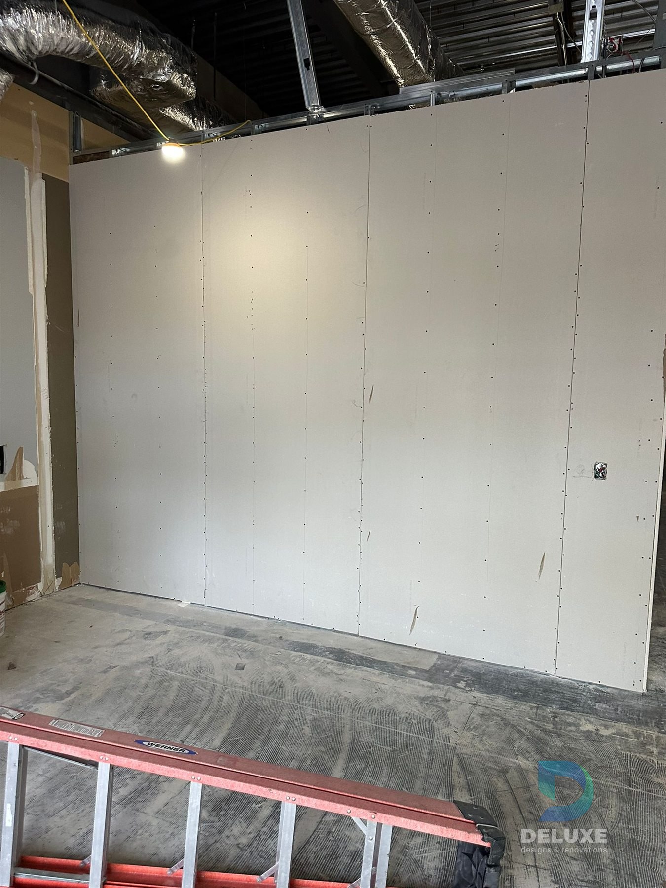 Milan Laser Valrico commercial buildout project with Deluxe Designs & Renovations watermark - Milan Laser Valrico Drywall Panel Install