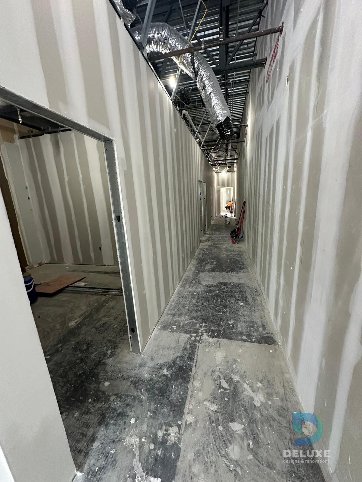 Milan Laser Valrico commercial buildout project with Deluxe Designs & Renovations watermark - Milan Laser Valrico Final Hallway View