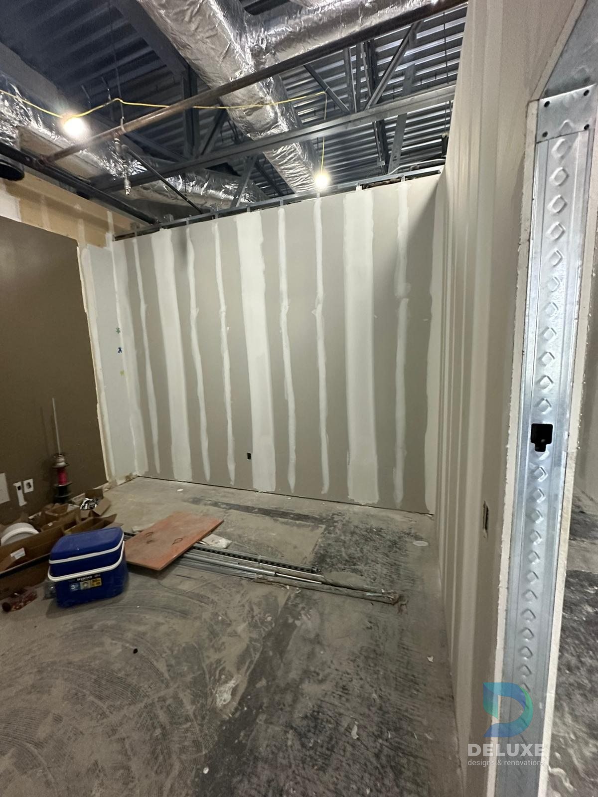 Milan Laser Valrico commercial buildout project with Deluxe Designs & Renovations watermark - Milan Laser Valrico Final Room Drywall