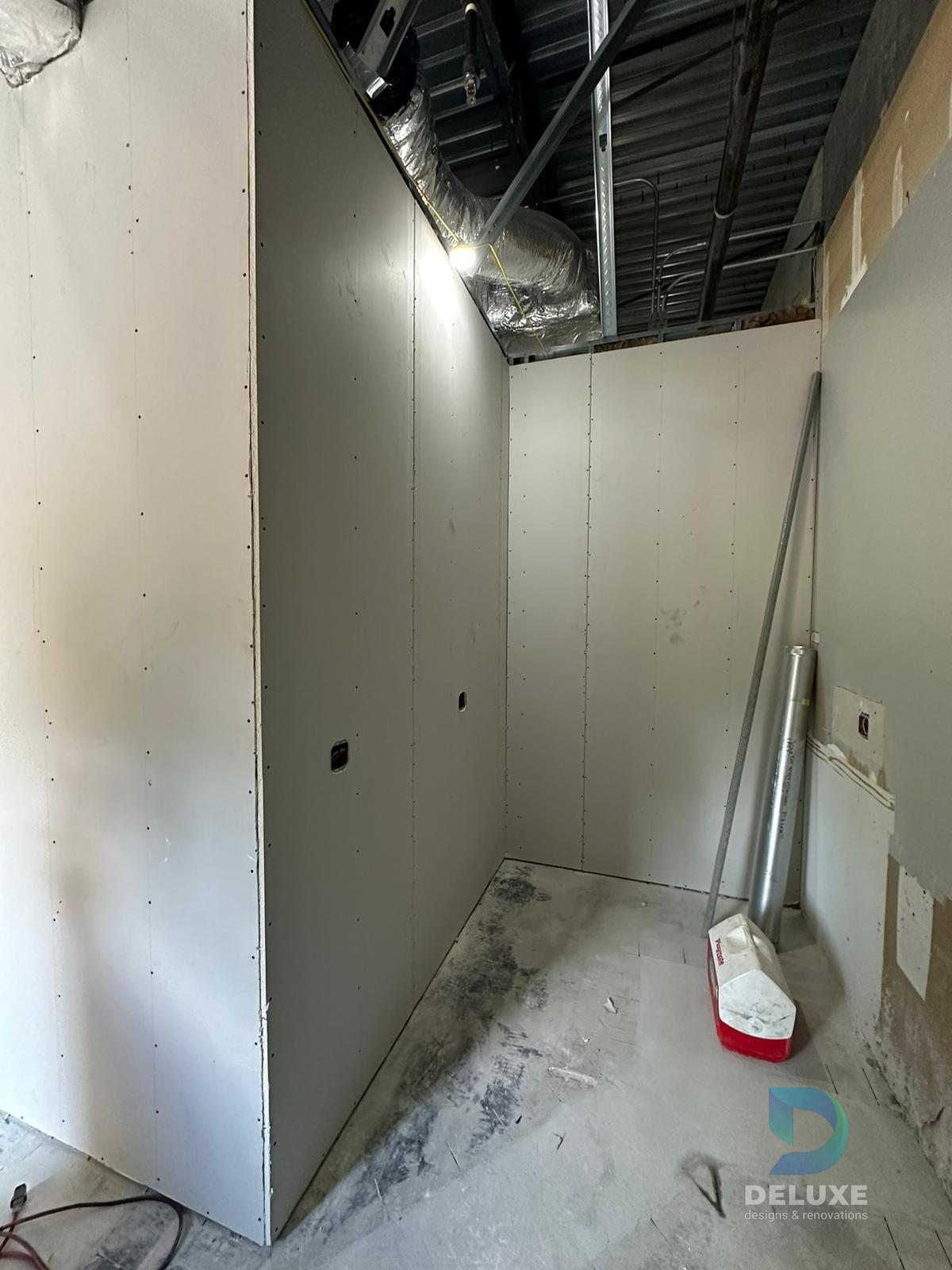 Milan Laser Valrico commercial buildout project with Deluxe Designs & Renovations watermark - Milan Laser Valrico Finished Wall Progress
