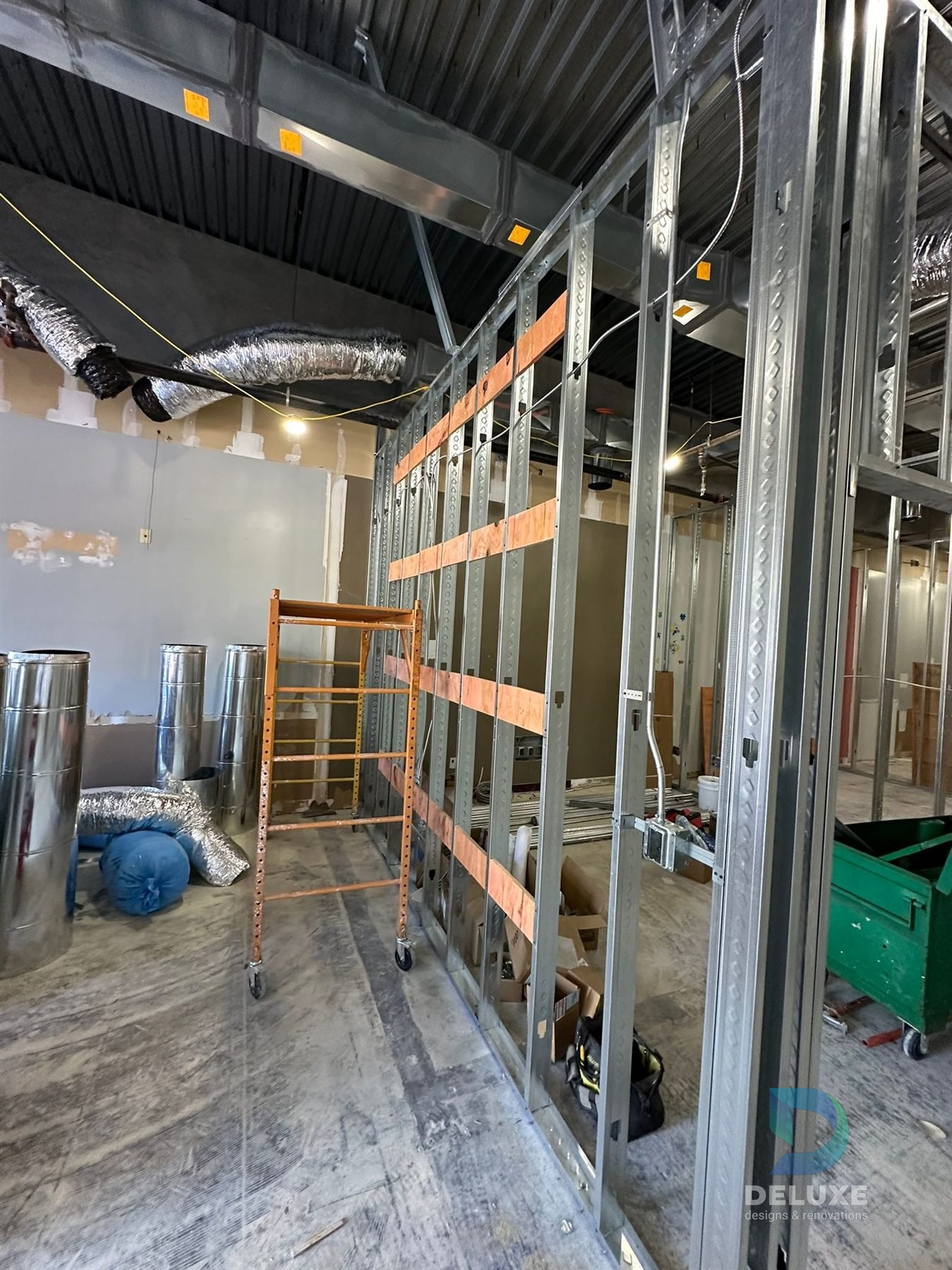Milan Laser Valrico commercial buildout project with Deluxe Designs & Renovations watermark - Milan Laser Valrico High Wall Framing
