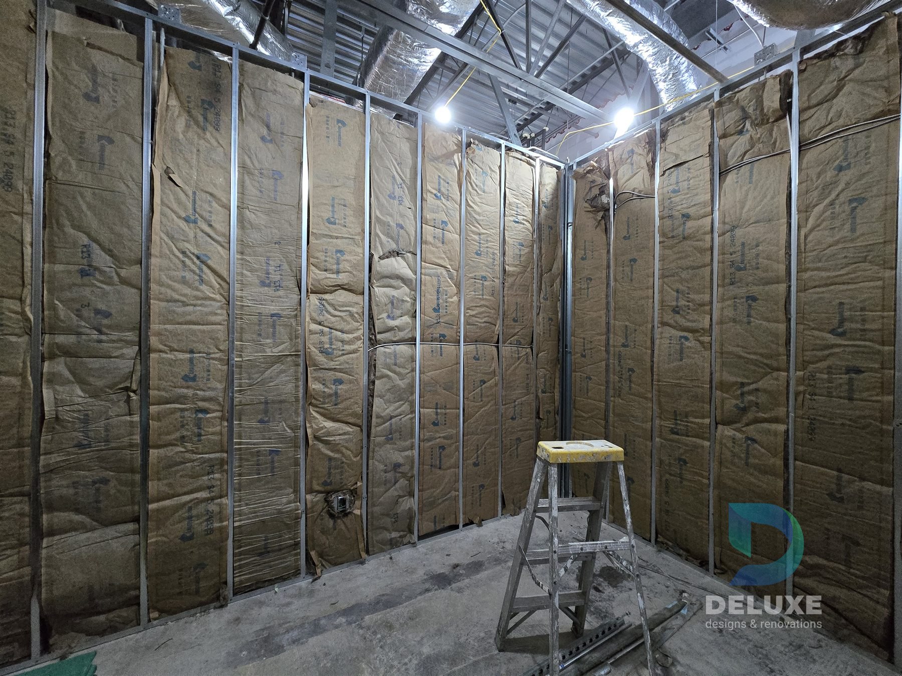 Milan Laser Valrico commercial buildout project with Deluxe Designs & Renovations watermark - Milan Laser Valrico Insulated Wall Progress
