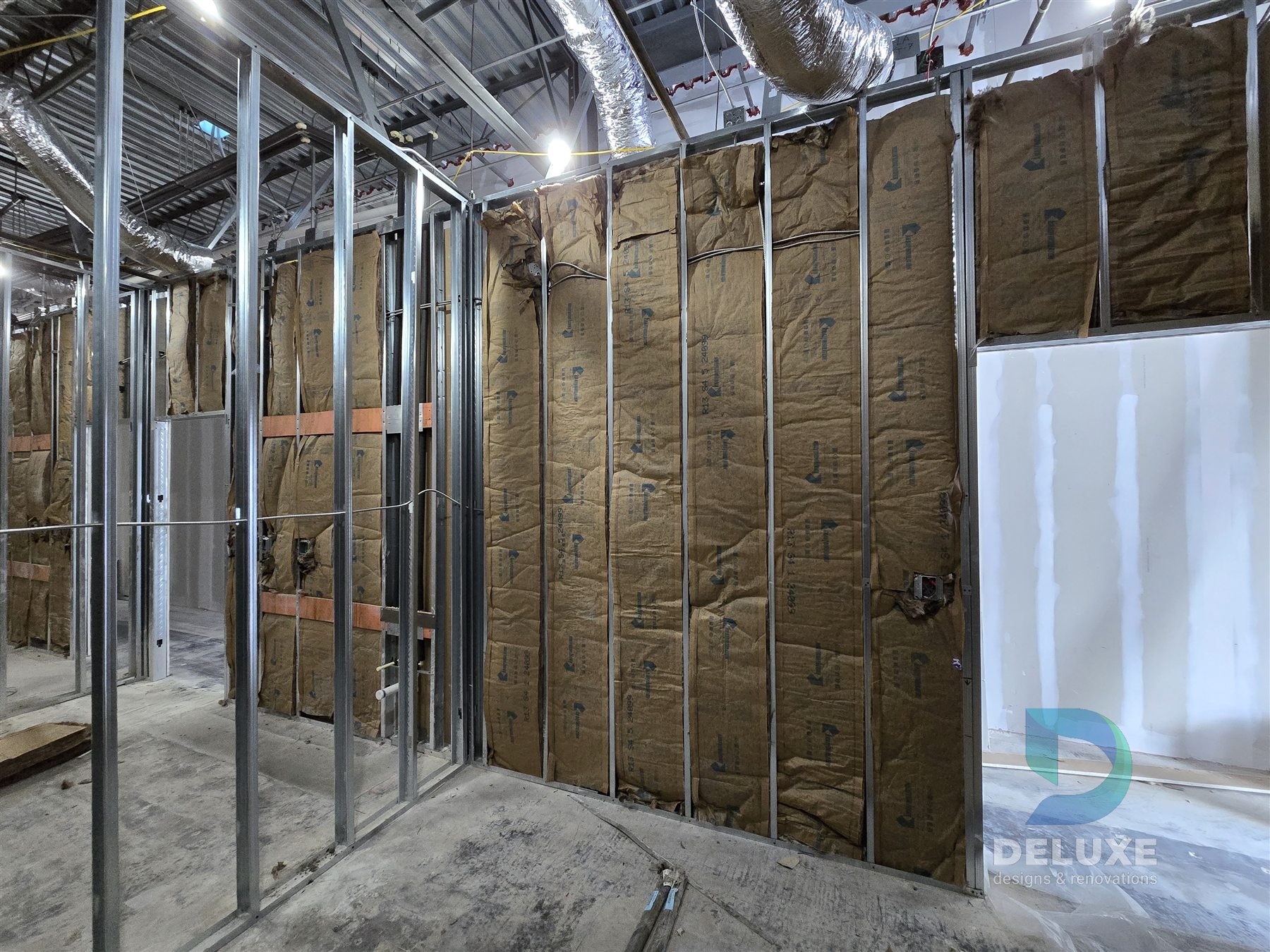 Milan Laser Valrico commercial buildout project with Deluxe Designs & Renovations watermark - Milan Laser Valrico Insulation And Framing